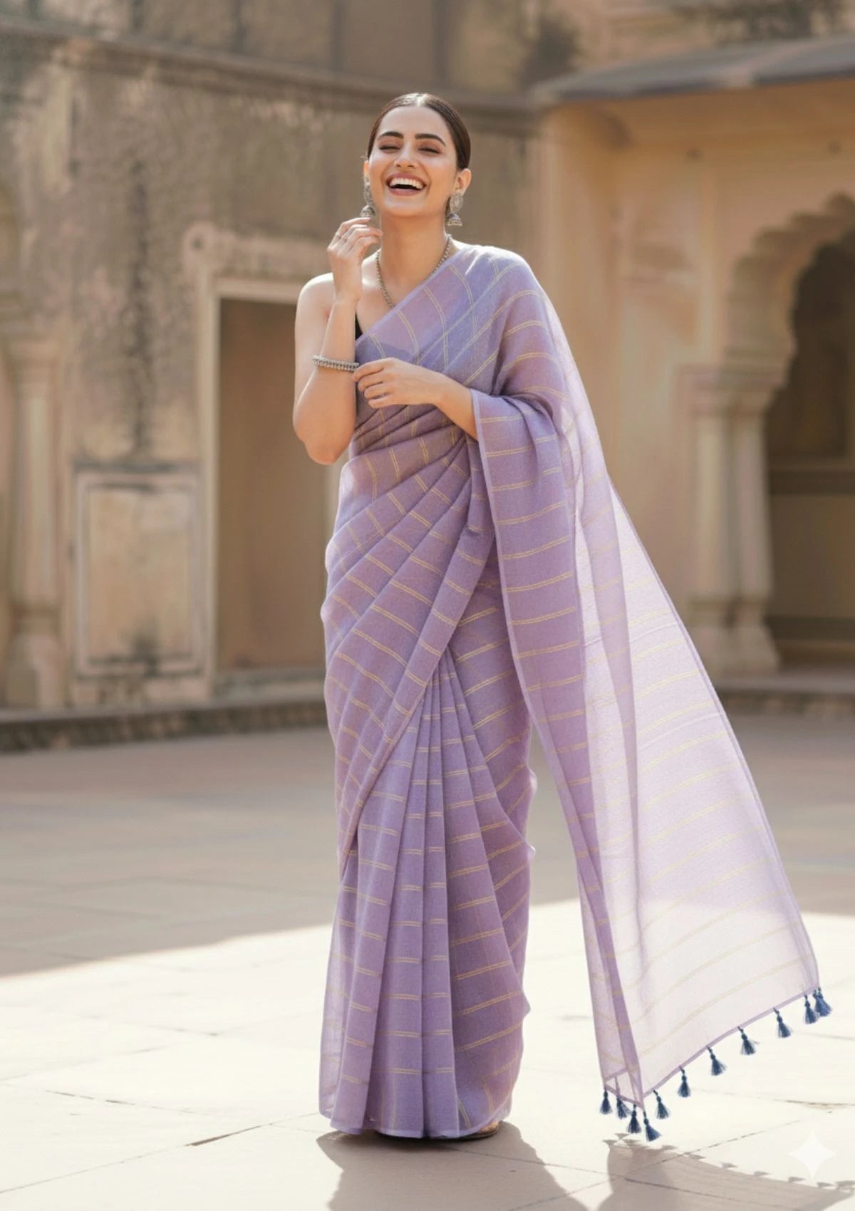 Ira  Light Purple Soft Mulmul Cotton Saree with Gold Zari Stripes and Tassels