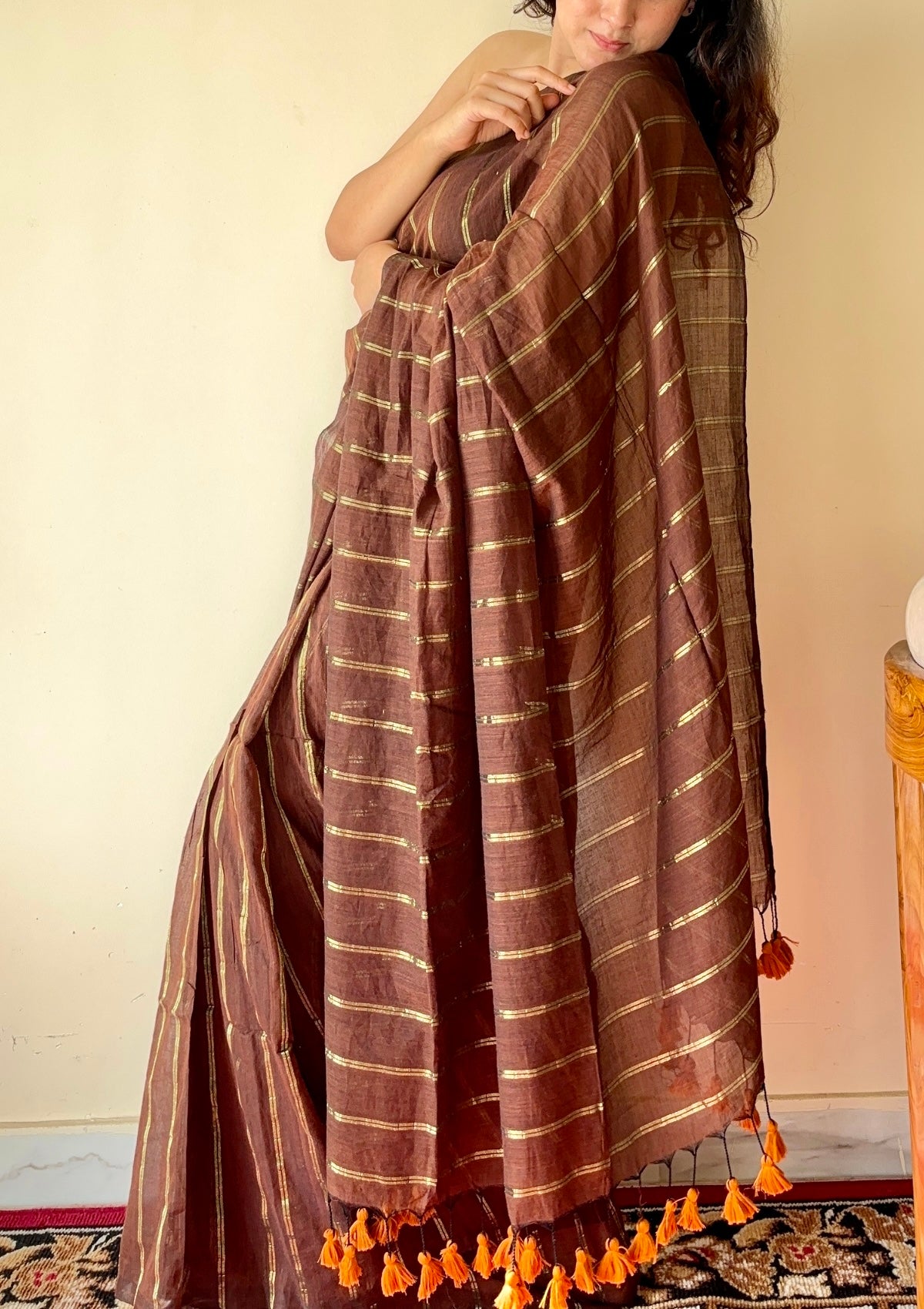Vedika  Chocolate Brown Mulmul Cotton Saree with Gold Zari Stripes and Tassels - Qatha 